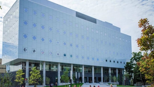 Campus building with students walking outside