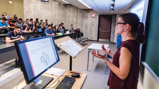 Students in lecture hall, learning from professor