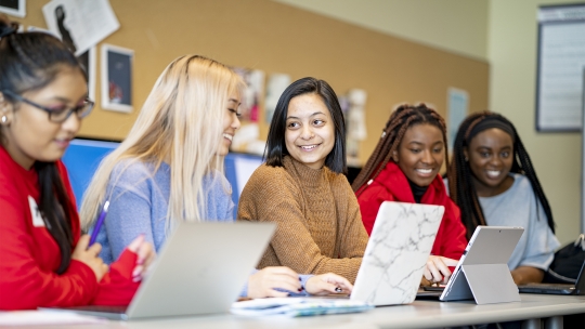 Five students in class in a non-traditional classroom