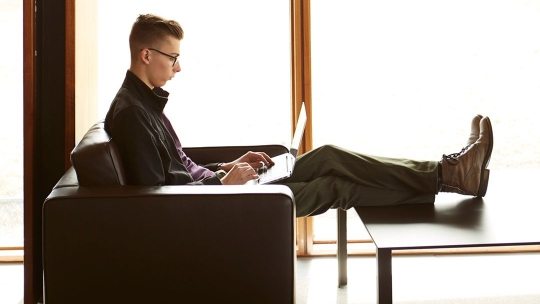 Male student working on laptop