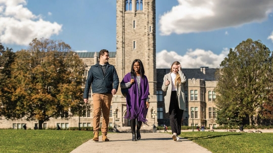 Three students walking on campus